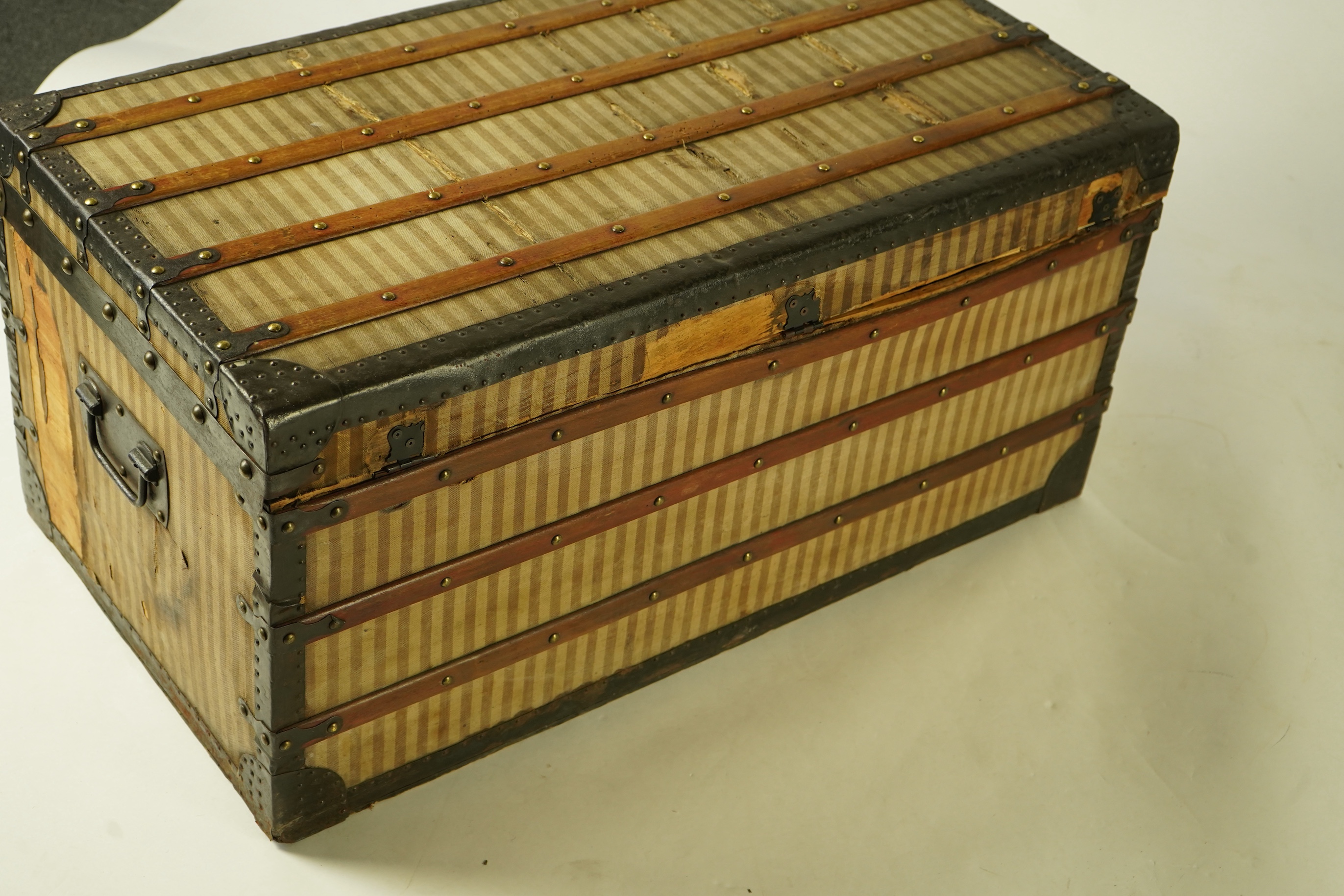 A vintage Louis Vuitton trunk with paper label to the interior numbered 142678, height 43cm, width 90cm, depth 48cm
